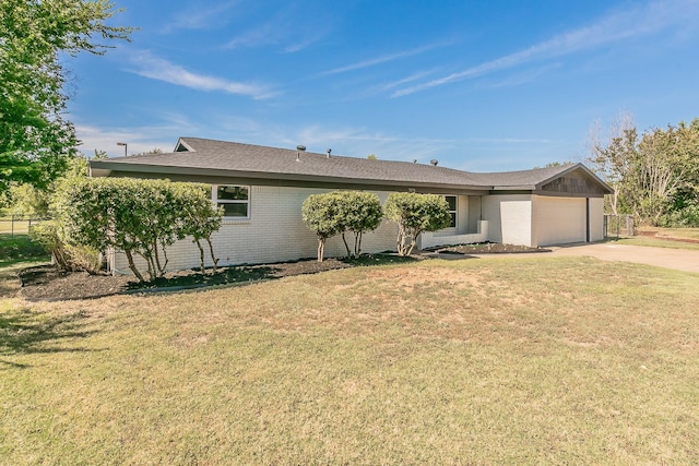 ranch-style home with a front lawn and a garage