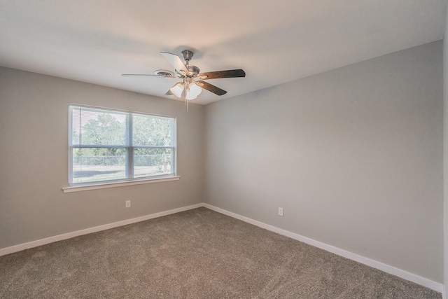 carpeted spare room featuring ceiling fan