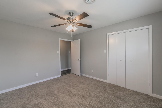 unfurnished bedroom with ceiling fan, carpet flooring, and a closet