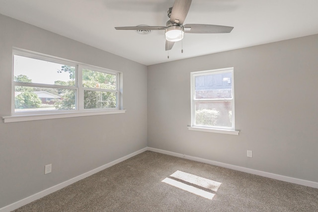 unfurnished room with ceiling fan and carpet flooring