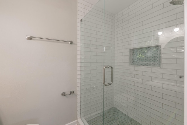 bathroom with an enclosed shower and toilet