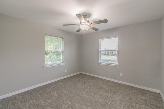 spare room featuring ceiling fan and carpet flooring