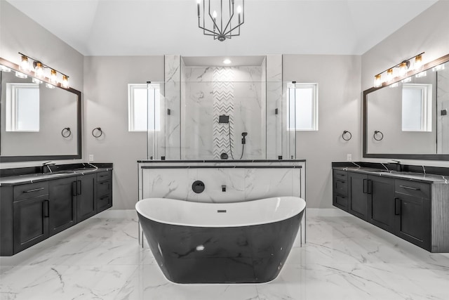 bathroom featuring vanity, independent shower and bath, and an inviting chandelier