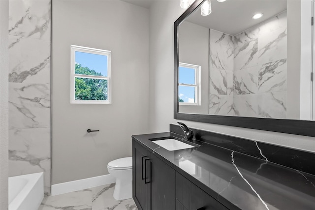 full bathroom featuring toilet, plenty of natural light, vanity, and washtub / shower combination