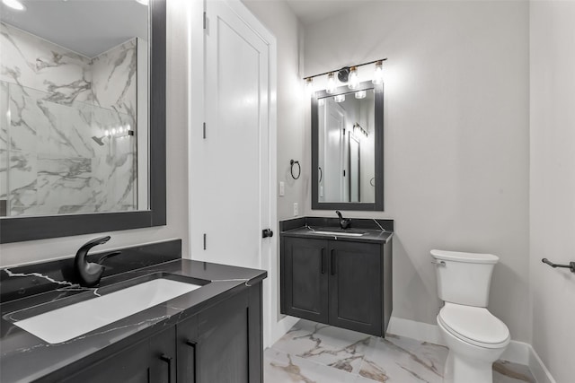 bathroom featuring toilet, vanity, and walk in shower