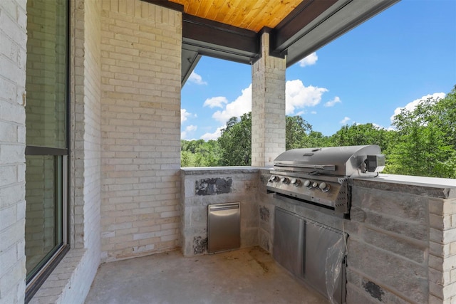 view of patio with an outdoor kitchen and area for grilling