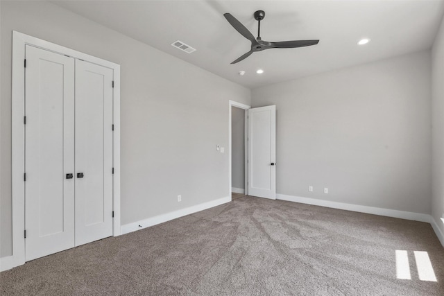 unfurnished bedroom with recessed lighting, a ceiling fan, baseboards, visible vents, and carpet