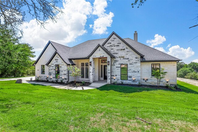 view of front of house with a front lawn and a garage