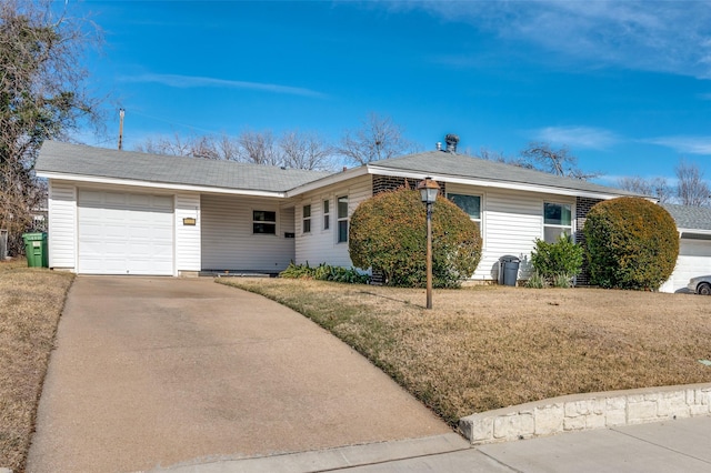 ranch-style house featuring a front yard and a garage