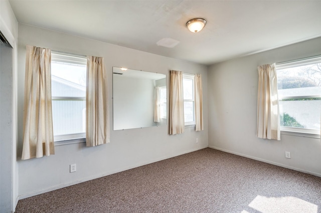 carpeted spare room with plenty of natural light