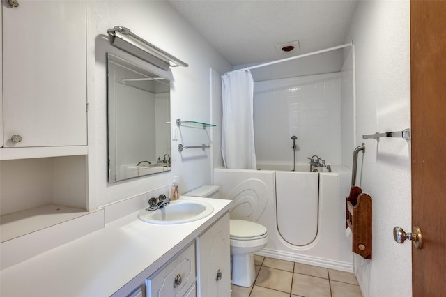 bathroom featuring toilet, vanity, and tile patterned flooring