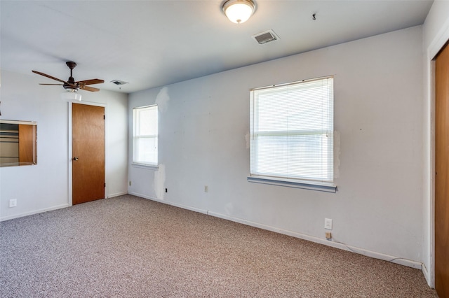 unfurnished bedroom with ceiling fan and carpet