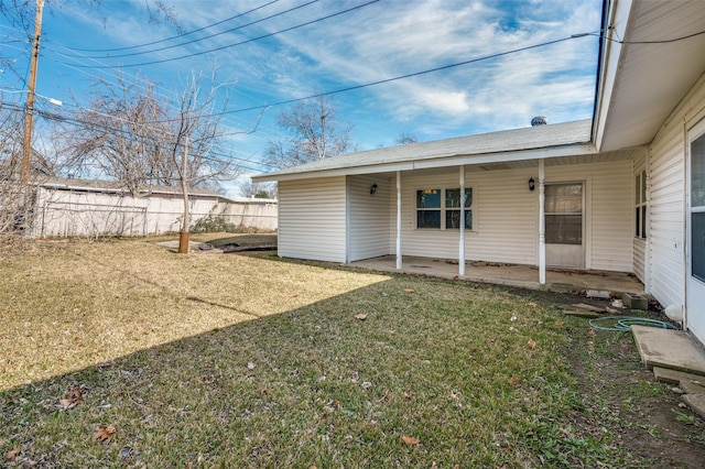 rear view of property featuring a patio area and a yard