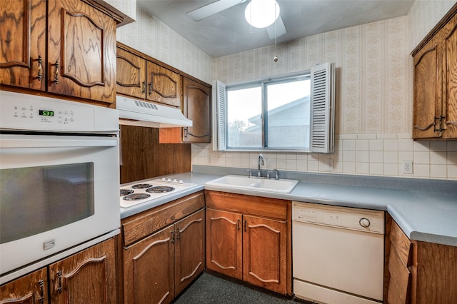 kitchen with ceiling fan, backsplash, sink, and white appliances