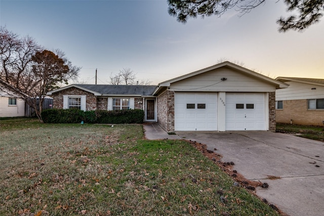 single story home with a garage and a lawn