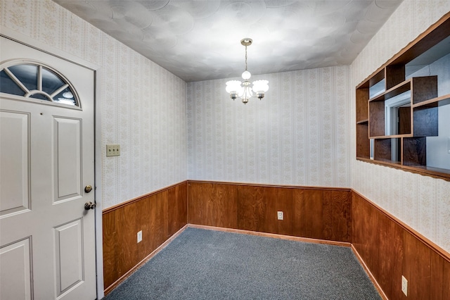 interior space with wooden walls and a chandelier