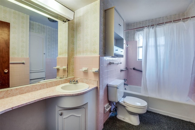 full bathroom featuring tile walls, toilet, vanity, and shower / tub combo with curtain