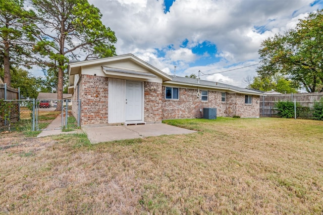 back of property featuring a yard, a patio, and cooling unit