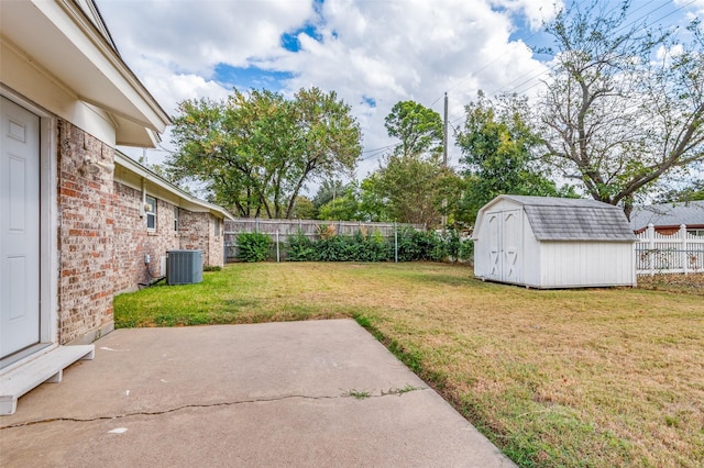 view of yard with a storage shed, central air condition unit, and a patio area