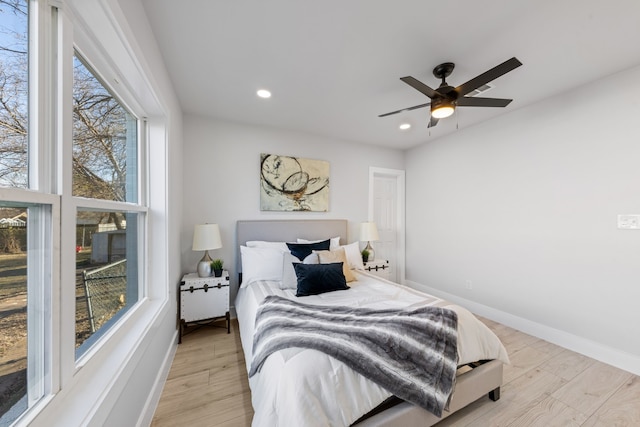 bedroom with ceiling fan and light hardwood / wood-style floors