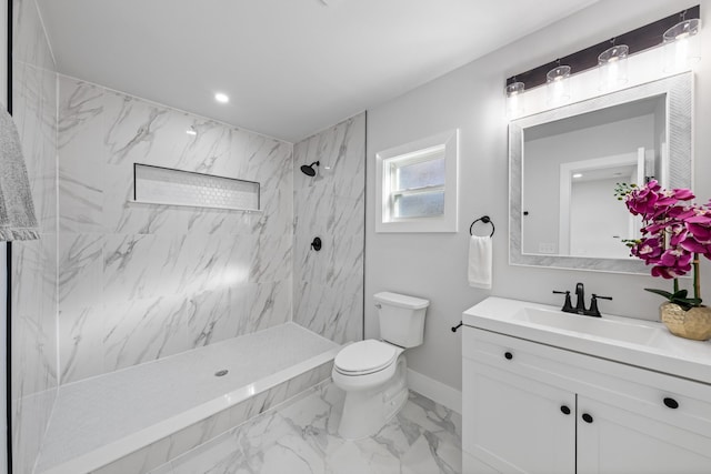 bathroom featuring tiled shower, vanity, and toilet