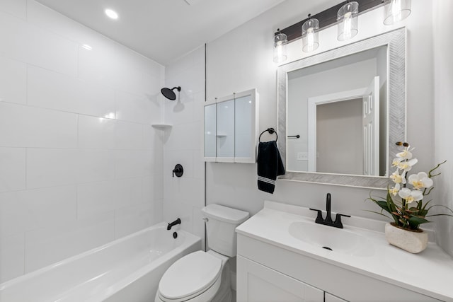 full bathroom with toilet, tiled shower / bath, and vanity