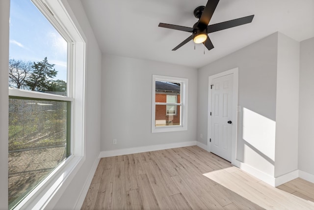 empty room featuring ceiling fan and light hardwood / wood-style flooring