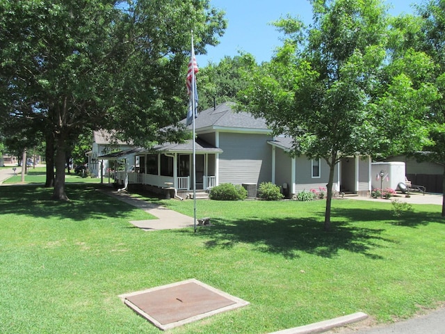 exterior space with a front yard and central AC unit