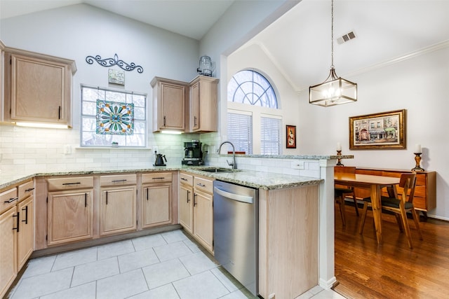 kitchen featuring dishwasher, lofted ceiling, light brown cabinets, decorative backsplash, and kitchen peninsula