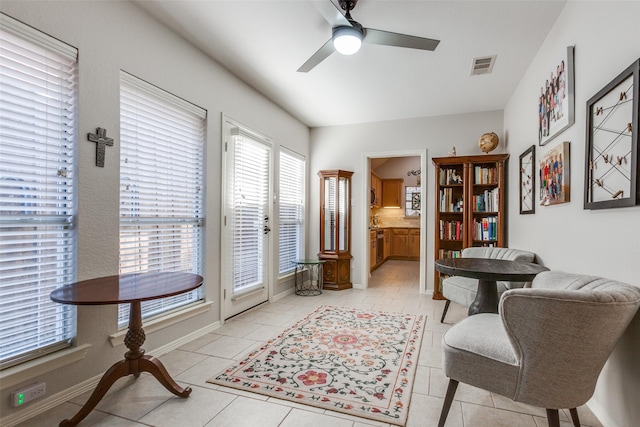 living area featuring ceiling fan, french doors, and light tile patterned flooring