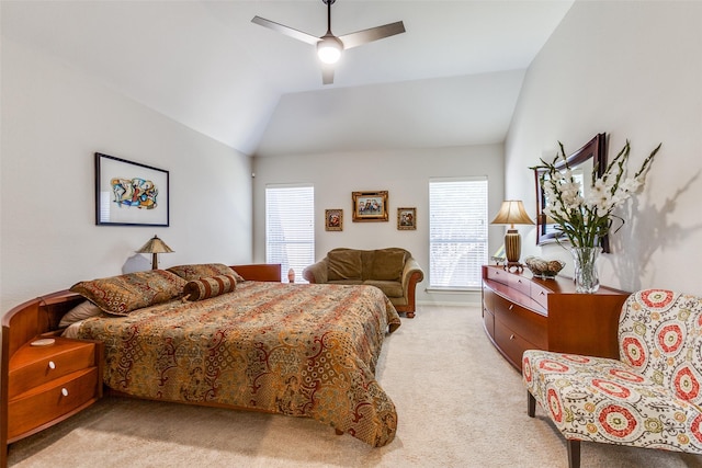 carpeted bedroom with ceiling fan and vaulted ceiling