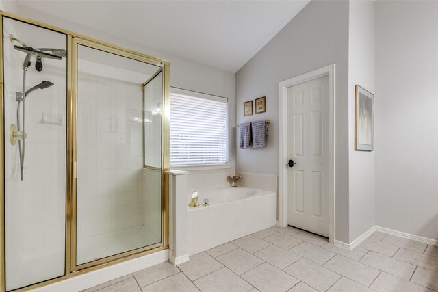 bathroom featuring shower with separate bathtub, lofted ceiling, and tile patterned flooring