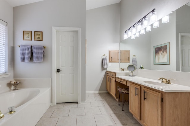 bathroom with vanity, tile patterned flooring, and a washtub