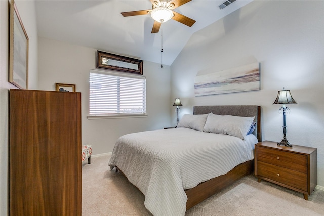 carpeted bedroom with ceiling fan and vaulted ceiling