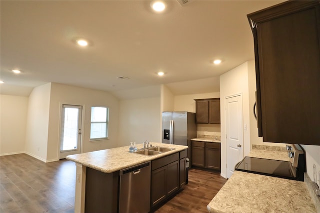 kitchen with an island with sink, dark wood finished floors, stainless steel appliances, and light countertops