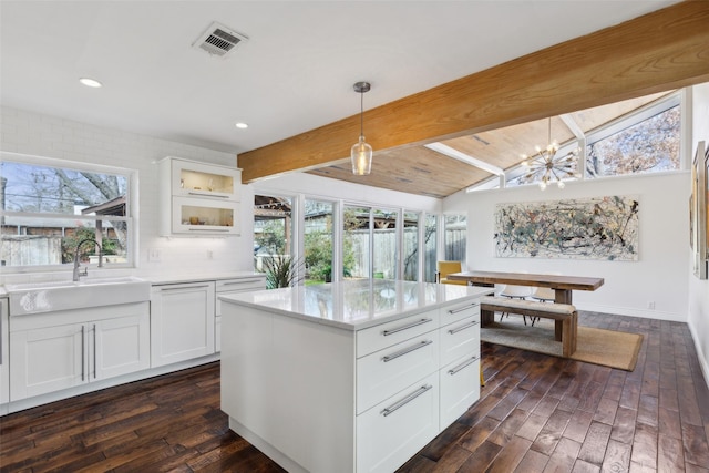 kitchen with decorative light fixtures, white cabinetry, dark hardwood / wood-style floors, and a wealth of natural light