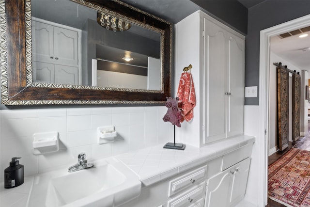 bathroom with sink and tasteful backsplash