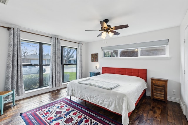 bedroom with ceiling fan and dark hardwood / wood-style flooring