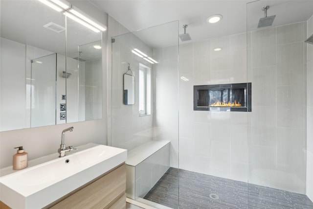 bathroom featuring vanity and tiled shower