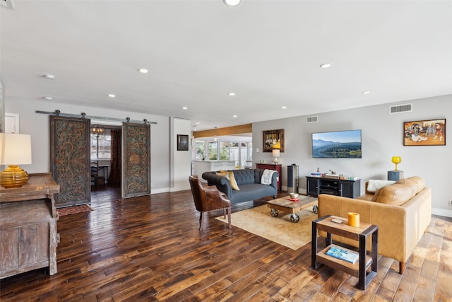 living room featuring hardwood / wood-style floors and a barn door