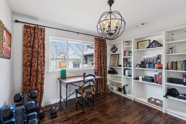 office with a notable chandelier and dark wood-type flooring