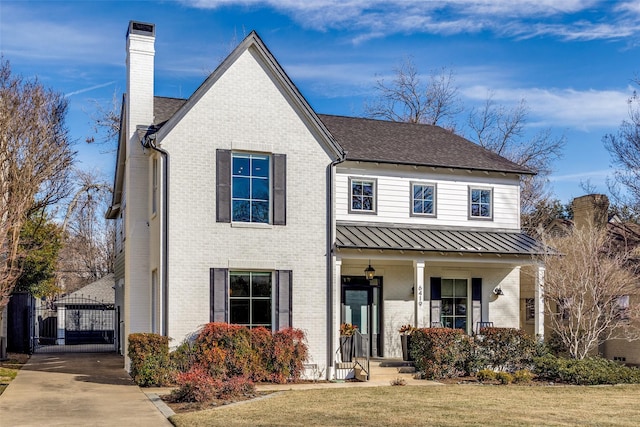 view of front of property featuring covered porch and a front lawn