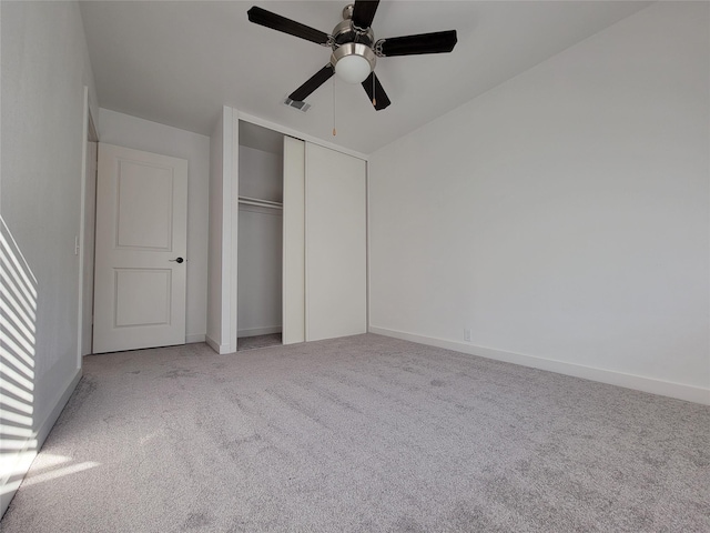 unfurnished bedroom with ceiling fan, a closet, and light colored carpet