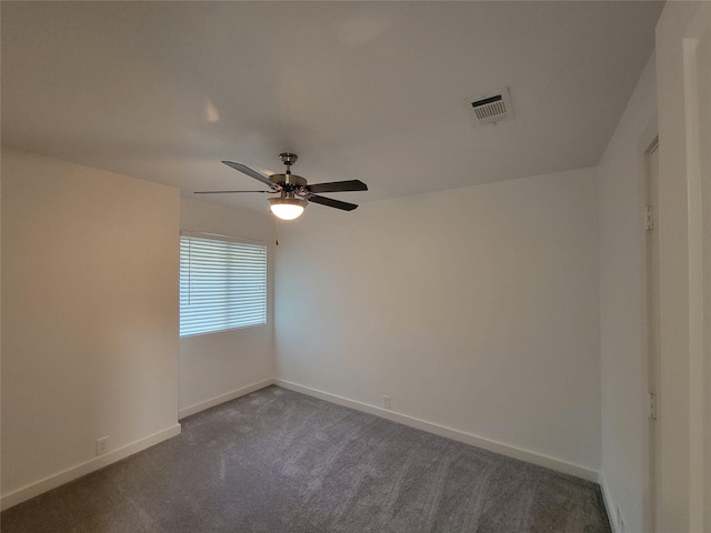 empty room featuring ceiling fan and dark carpet