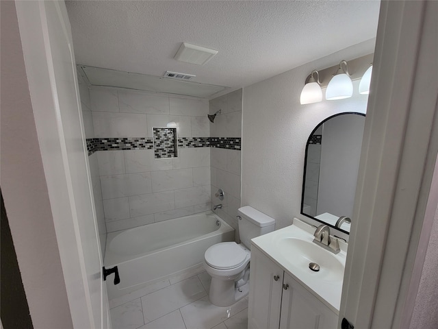 full bathroom with toilet, vanity, tiled shower / bath, tile patterned floors, and a textured ceiling