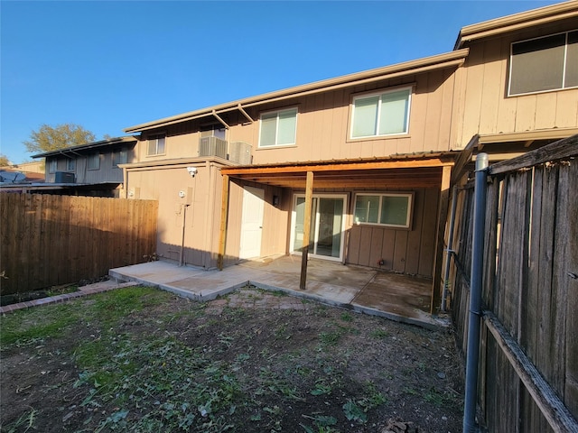 back of property with a balcony and a patio