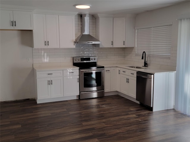 kitchen featuring white cabinetry, wall chimney range hood, and stainless steel appliances