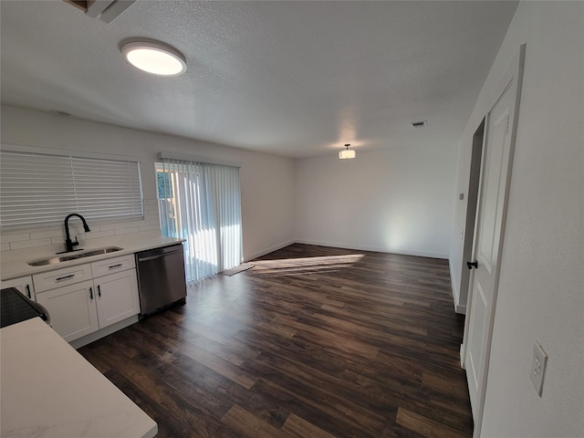 kitchen featuring tasteful backsplash, dark hardwood / wood-style flooring, dishwasher, white cabinets, and sink