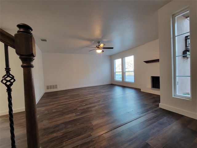 unfurnished living room with ceiling fan and dark wood-type flooring