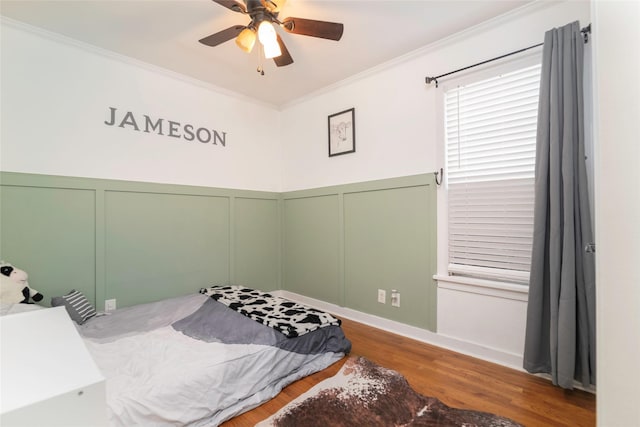 bedroom with ceiling fan, crown molding, and hardwood / wood-style flooring